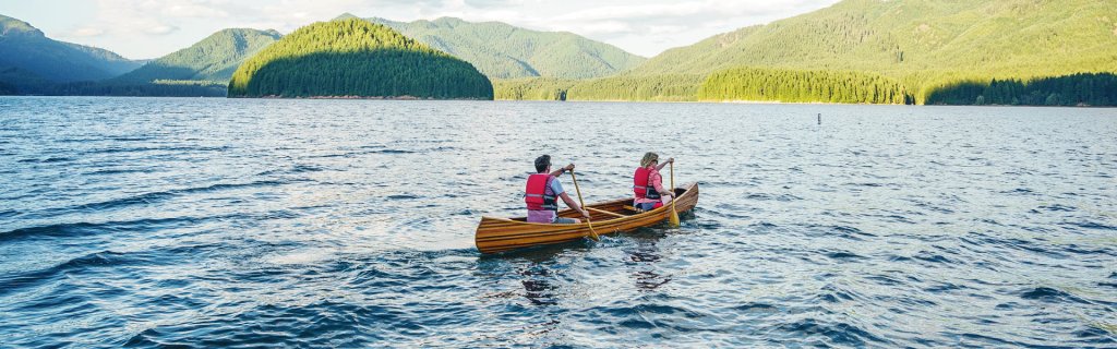 A woman and man in a canoe out on Detroit lake