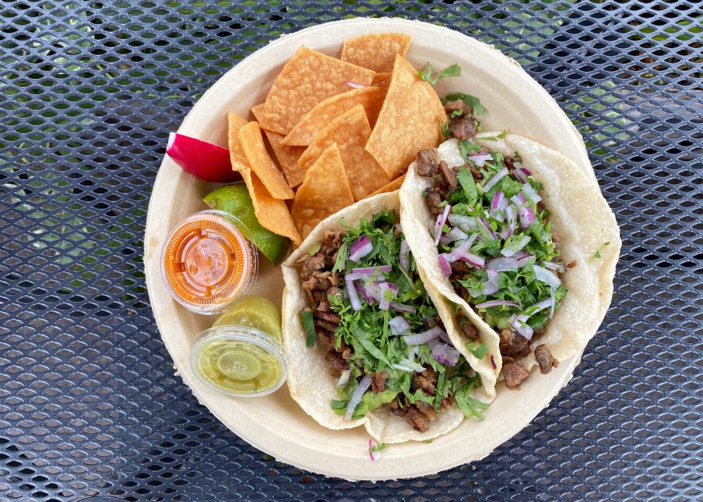 A plate of tacos and chips from Dos Mundos.